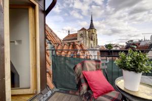 a chair on a balcony with a view of a building at Charming APT Old Town Prague by Michal&Friends in Prague