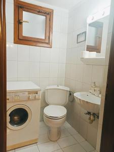 a small bathroom with a toilet and a sink at Sunny Loft in Kavála +20 photos