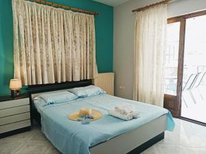a bedroom with a bed with towels on it at Sunny Loft in Kavála