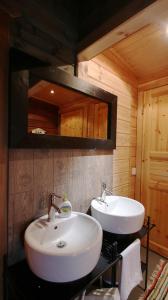 a bathroom with a white sink and a mirror at Hotel Taivaanvalkeat in Köngäs