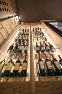 a display case full of bottles of wine at Alevic Hotel Sirmione in Sirmione