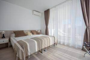Hotel & Apartments Eldorado tesisinde bir odada yatak veya yataklar