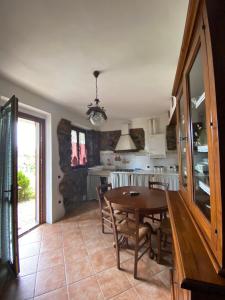 a kitchen and dining room with a table and chairs at Agribike Agriturismo Poggio Rossino in Gavorrano