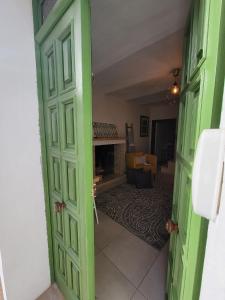une porte ouverte sur un salon avec une cheminée dans l'établissement Ancient Stone 'Casa Rosa'- Sea and Mountain View Tranquil Borgo, à Tavenna