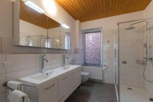 a bathroom with a sink and a toilet and a shower at Haus Relax, Whg 3 in Duhnen