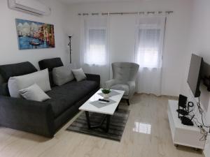 a living room with a couch and a table at Apartmani Marija in Vrdnik