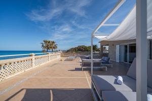 a view of the ocean from the deck of a house at Punta Prima Apartments by 3VILLAS in Punta Prima