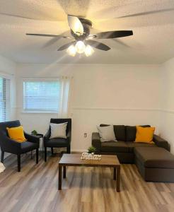 a living room with a couch and a ceiling fan at Sparkling Guest Home 2 bedroom-15 Minutes to Clearwater Beach in Clearwater