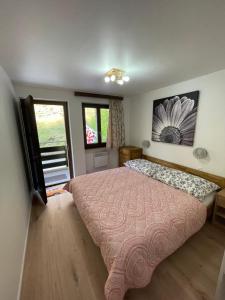 a bedroom with a large bed with a pink bedspread at Osteria Posse in Lavertezzo