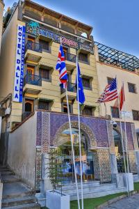 a hotel with flags in front of it at Hotel & Ryad DALILA in Fès