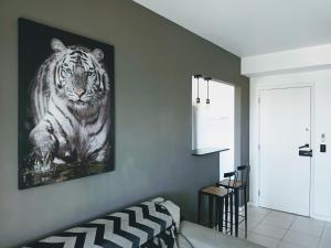 a room with a picture of a tiger on the wall at Lindo apto Recreio RJ, em frente ao Rio Centro in Rio de Janeiro