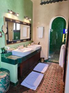 a bathroom with two sinks and a large mirror at Riad Le Calife in Fès +48 photos