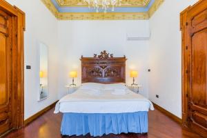 Posteľ alebo postele v izbe v ubytovaní Palazzo Montalbano