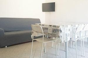 a table with chairs and a bed with a newspaper on it at Marotta, 300 mt dal mare, Sea & City Apartments, Sea&Business, Wi-Fi fibra, parking, 3 camere, 11 letti in Marotta +22 photos