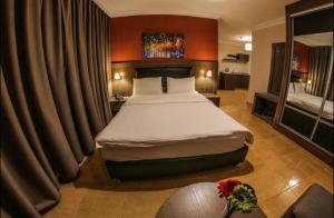 a bedroom with a large bed in a hotel room at Ibiza Hotel in Amman