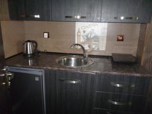 a kitchen with a sink and a counter top at batumi orbi sea tawers in Batumi