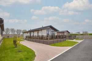 a house with a brick walkway in front of it at Host & Stay - Puffins Rest in Runswick