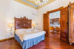 Posteľ alebo postele v izbe v ubytovaní Palazzo Montalbano