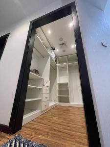 a large mirror in a room with a closet at Yacob's The Nest in Ajman 