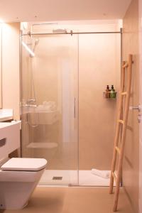 a bathroom with a shower, toilet and sink at Apartamentos Llobet Ibiza in Ibiza Town