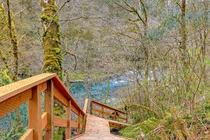 a wooden bridge in the middle of a forest at RiverSong in Tillamook +21 photos