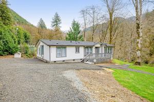 a home in the mountains with a driveway at RiverSong in Tillamook