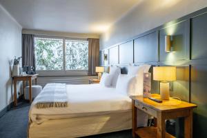 a hotel room with a large bed and a window at Grand Hôtel Courchevel 1850 in Courchevel