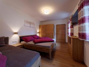 a bedroom with two beds with red pillows at Urlaub am Obsthof Pieber in Weiz