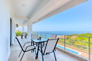 a dining room with a table and chairs on a balcony at Apartmani Panorama in Bar