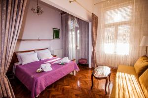 a hotel room with two beds and a couch at The routes of Habsburg (beach 70 m) in Opatija