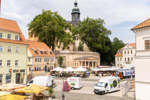 a city square with a large building with a tower at Wohnen am Schloss, Schlossblick in Sondershausen