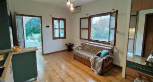 a living room with a bench in a room with windows at Garden Bungalow Valentina in Stavros +61 photos
