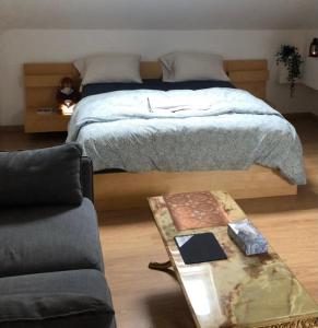 a bedroom with a bed and a coffee table at FERTILE in Charleroi