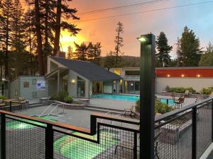 a house with a swimming pool and a fence at Slopeside 1849 Condos - Comfortable 3 BR Condos with Full Kitchens in Mammoth Lakes