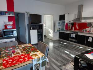 a kitchen with a dining room table and a kitchen with at Ferienwohnung Mahlsdorf in Berlin