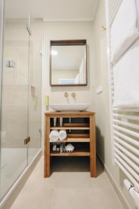 a bathroom with a sink and a shower at Boutiquehotel Kloster Pfalzel in Trier