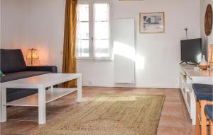 a living room with a couch and a table at 1 Bedroom Lovely Apartment In Noirmoutier-en-lle in Noirmoutier-en-l'lle