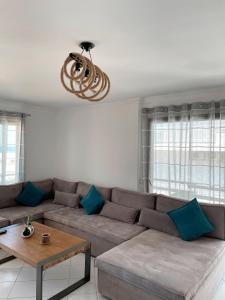 a living room with a couch and a chandelier at Blue View Seaside Luxury Apartments in Ixia