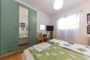 a bedroom with two beds and a mirror at Apartment Tolja in Dubrovnik