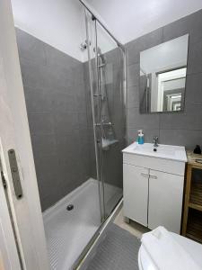 a bathroom with a shower and a toilet and a sink at Antique, Amazing double room in Marques de Pombal with shared Bathroom in Lisbon