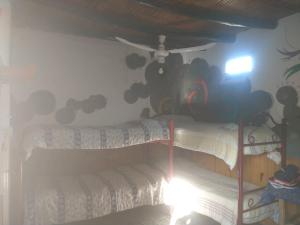 a bedroom with two bunk beds with clouds on the wall at Eco Hostel Valle Fertil in San Agustín de Valle Fértil