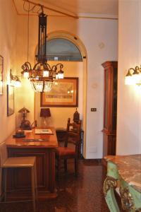 a dining room with a table and a chandelier at Dimora del Bonsignore in Turin