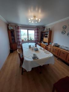 a kitchen with a large table in the middle of a room at Scorrybreac B&B in Broadford