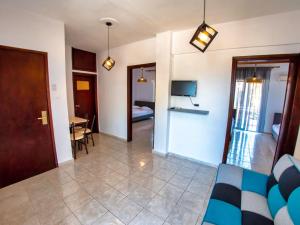 a living room with a couch and a dining room at Prassas Sea View in Nea Potidaea