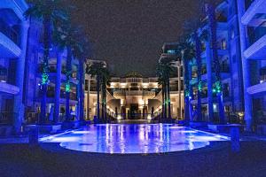 a large building with a fountain in front of it at night at בוטיק לה פלמורה אילת in Eilat