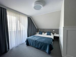 מיטה או מיטות בחדר ב-Marina Śniardwy Resort