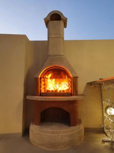 a brick oven with a fire inside of it at B&S Accommodation Penthouse 602 in Hal Ghaxiak