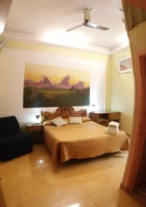 a bedroom with a bed and a painting on the wall at walter guest house in Rome