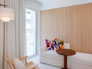 a living room with a white couch and a table at The Standard, Ibiza in Ibiza Town +86 photos