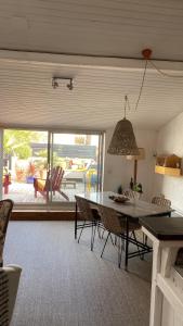 a kitchen and dining room with a table and chairs at La Terrasse du Bois Plage in Le Bois-Plage-en-Ré